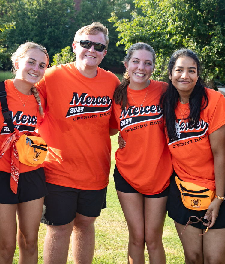 Four students pose for the camera on opening day